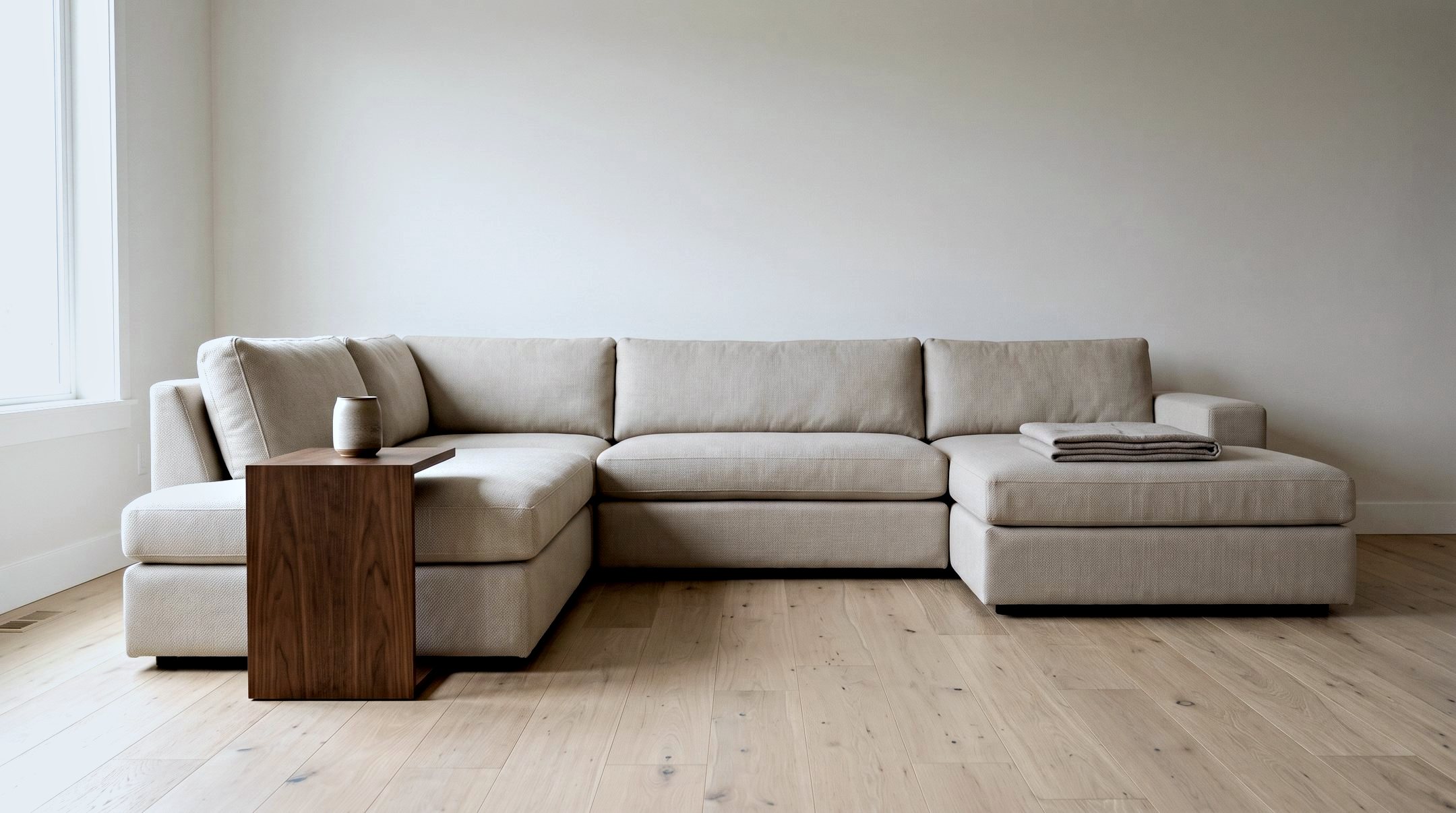 A large sectional sofa placed and squared in a bright open-plan living room