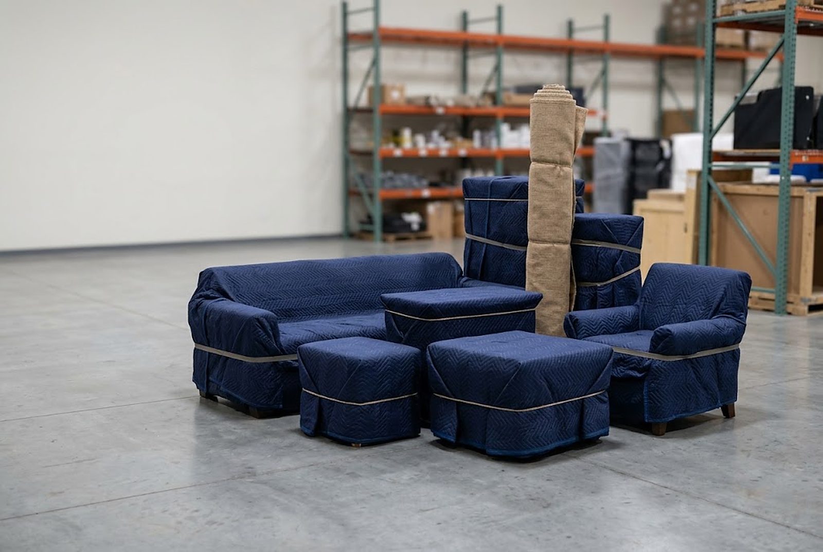 A single project staged together on the warehouse floor, each piece blanket-wrapped and tied